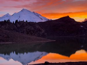 The sun setting behind Baker/Kulshan, with reflections in a small lake. 10/03/25