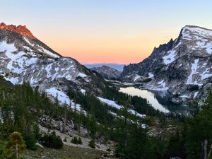 Perfection Lake, with Little Annapurna on the right, McClellan Peak on the left, and Rainier/Tahoma in the distance in the background, as seen from Prusik Pass on descending from climbing the west ridge of Prusik Peak. 07/06/25