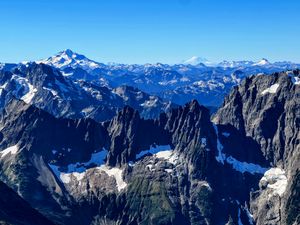 Layers in the Cascade Mountains, prominently featuring Glacier Peak and Ranier.  As seen from the west ridge of Forbidden Peak. 09/06/22