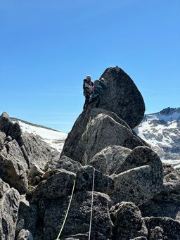 Ian and B tip-toeing around a large boulder on the traverse-y section of pitch three, after the (not-pictured) crux slab.