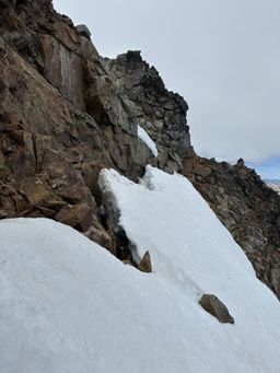 Looking back at the bergschrund on the steep snow slope that we crossed. We started by bridging across the gap at the far end, before swimming down into the moat and then climbing back out to where the photo is taken.